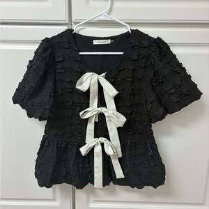 Elegant Black Blouse with White Bow Accents